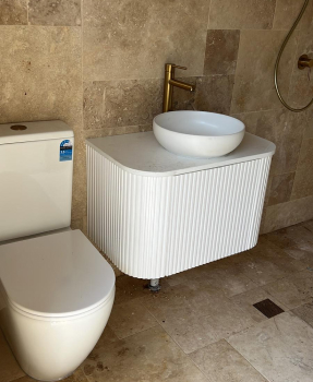 Completed bathroom with toilet, basin and vanity